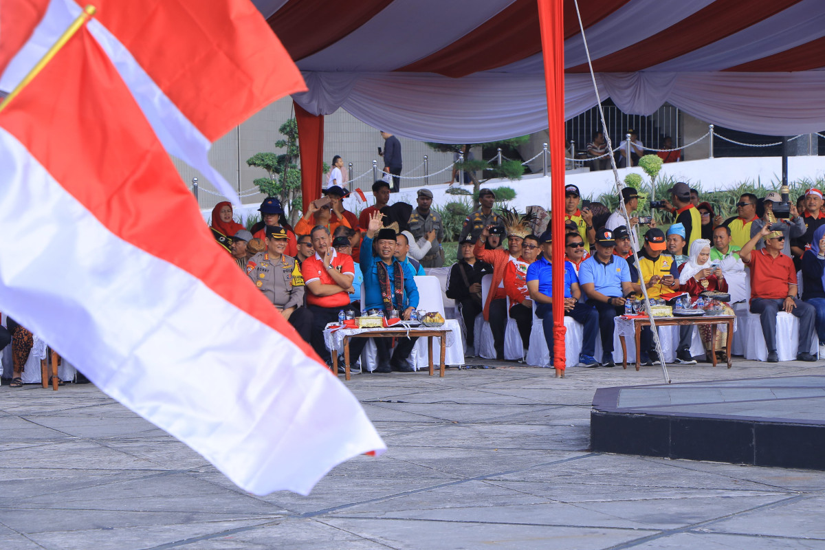 Sekretaris Daerah Kota Pekanbaru Indra Pomi Melambaikan Tangan Kepada Peserta Gerakan Pembagian Bendera Merah Putih.